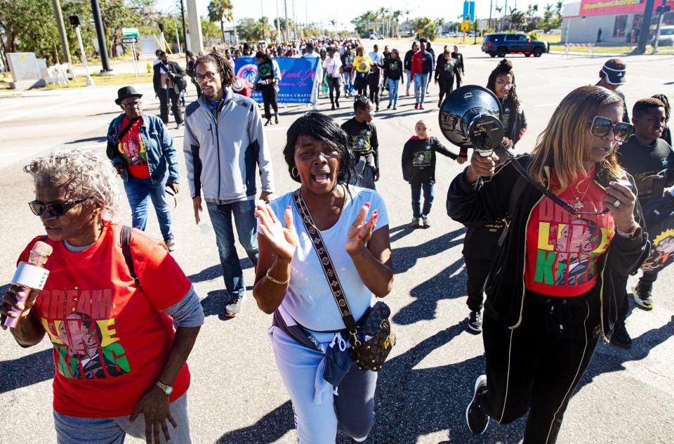 From left, Victoria Battle, Patricia Bronson and Katenia Mitchell lead participants in the Martin Luther King Jr. Commemorative March in Fort Myers on Jan. 16, 2023.  Hundreds participated in the annual event. 