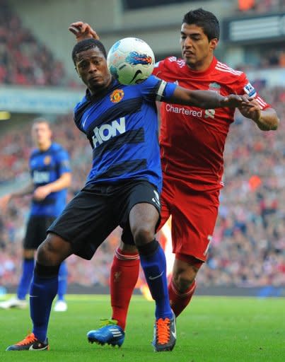 Liverpool's Luis Suarez (R) and Manchester United's Patrice Evra during an English Premier League match in October 2011. Suarez was banned for eight matches for using the Spanish word 'negrito' (little black) in a clash with Evra last season