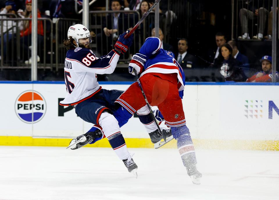 Columbus Blue Jackets left wing Kirill Marchenko (86) is checked by New York Rangers defenseman Jacob Trouba (8) during the first period of an NHL hockey game, Sunday, Nov. 12, 2023, in New York. (AP Photo/Noah K. Murray)