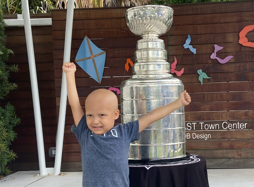 Kameron Bush, 3, poses with the Stanley Cup at the Children's Cancer Center in Tampa, Fla., on Oct. 16, 2020. The Tampa Bay Lightning took the Stanley Cup to the Children's Cancer Center as part of their local tour of stops after winning the National Hockey League's championship trophy Sept. 28 in Edmonton, Alberta. (Kristina Hjertkvist/Tampa Bay Lightning via AP)