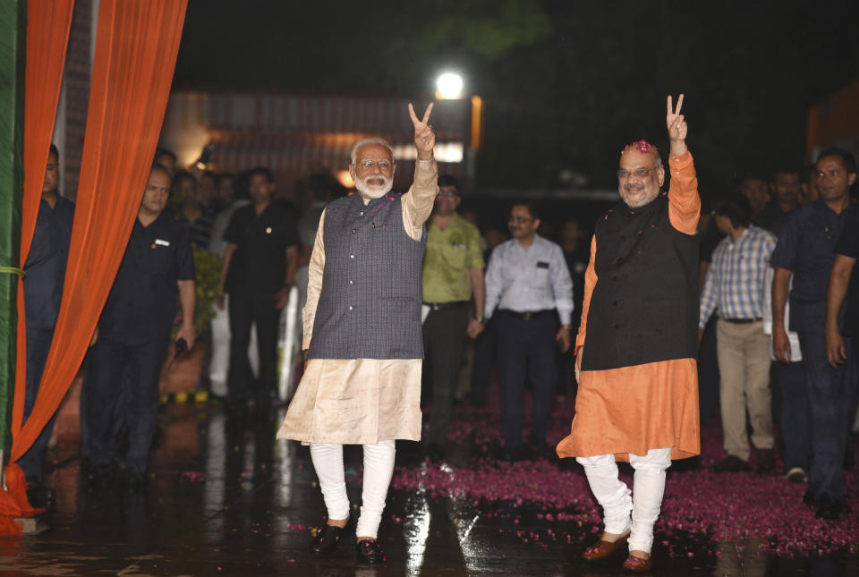 Indian Prime Minister Narendra Modi and Bharatiya Janata Party (BJP) President Amit Shah display the victory symbol to supporters on arrival at the party headquarters in New Delhi, India, Thursday, May 23, 2019. Modi's Hindu nationalist party claimed it won reelection with a commanding lead in Thursday's vote count, while the head of the main opposition party conceded a personal defeat that signaled the end of an era for modern India's main political dynasty. (AP Photo)