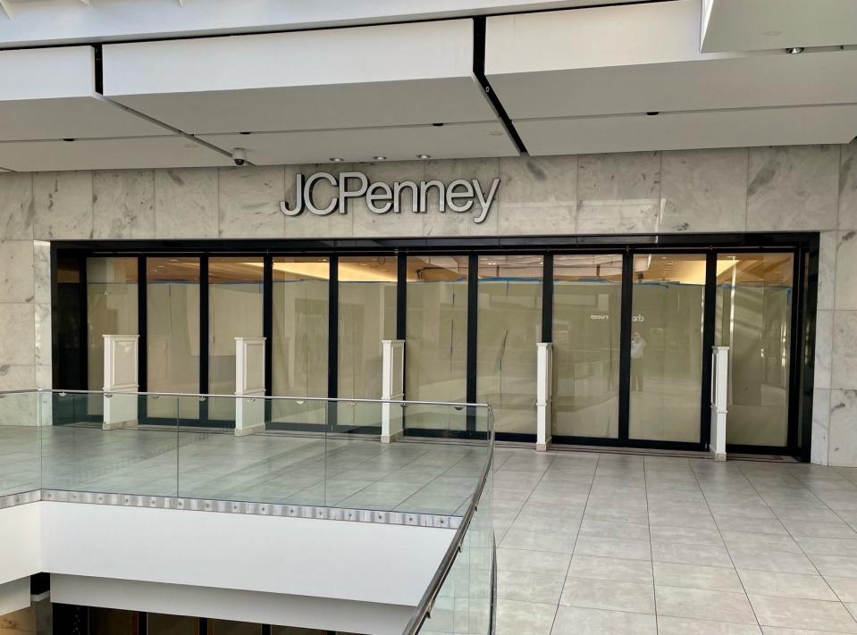 JCPenney sign at entrance to department store on second floor of mall.