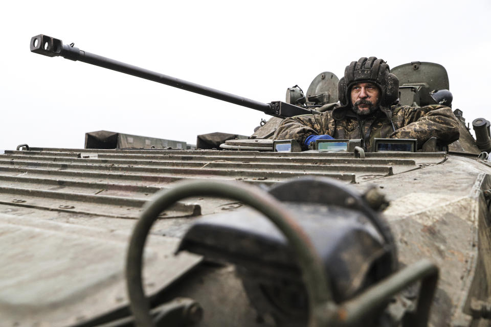 A Ukrainian soldier looks out of an APC during combat training in Zaporizhzhia region, Ukraine, Tuesday, Jan. 24, 2023. (AP Photo/Kateryna Klochko)