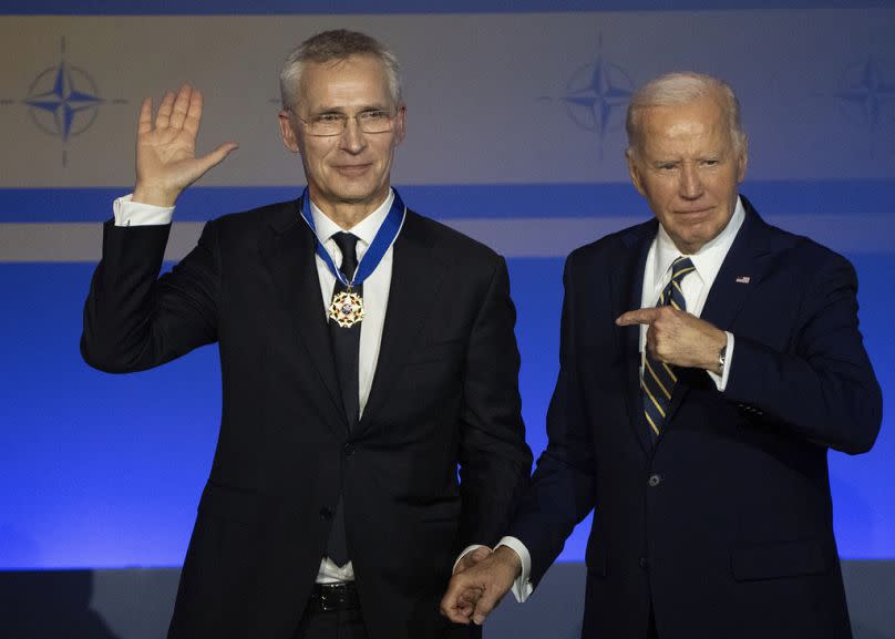 U.S. President Joe Biden points to NATO Secretary-General Jens Stoltenberg after presenting him with the Presidential Medal of Freedom during a ceremony celebrating NATO 75th