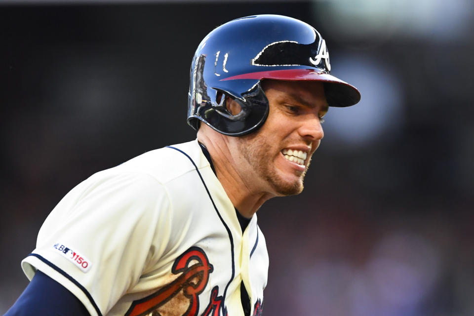 Atlanta Braves' Freddie Freeman rounds third base on the way to scoring on a line drive single to right field by Nick Markakis during the first inning of a baseball game against the Washington Nationals, Sunday, July 21, 2019, in Atlanta. (AP Photo/John Amis)