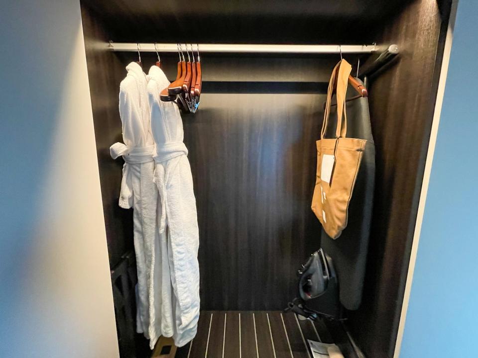 A reusable tote bag hangs in the closet of a room at The Hotel Britomart.