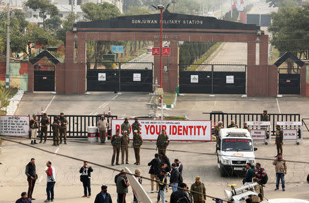 Indian police officers and soldiers stand guard outside an army camp after suspected militants attacked the camp, in Jammu February 10, 2018. REUTERS/Mukesh Gupta