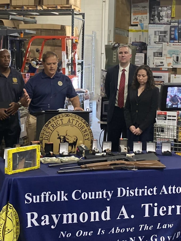 Suffolk County DA Raymond Tierney (second from right) led a bust of an illegal pawnshop where shoplifted goods were fenced, with many sold on eBay. One of the owners was also convicted of gun offenses.