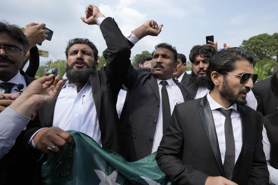 Lawyers chant slogans in favor of the country's imprisoned former Prime Minister Khan outside the Islamabad High Court in Islamabad, Pakistan, Thursday, Aug. 24, 2023. A court in Pakistan's capital is likely to issue a crucial ruling Thursday on an appeal from the country's imprisoned former Prime Minister Khan against his recent conviction and three-year sentence in a graft case, one of his lawyers said. (AP Photo/Anjum Naveed)