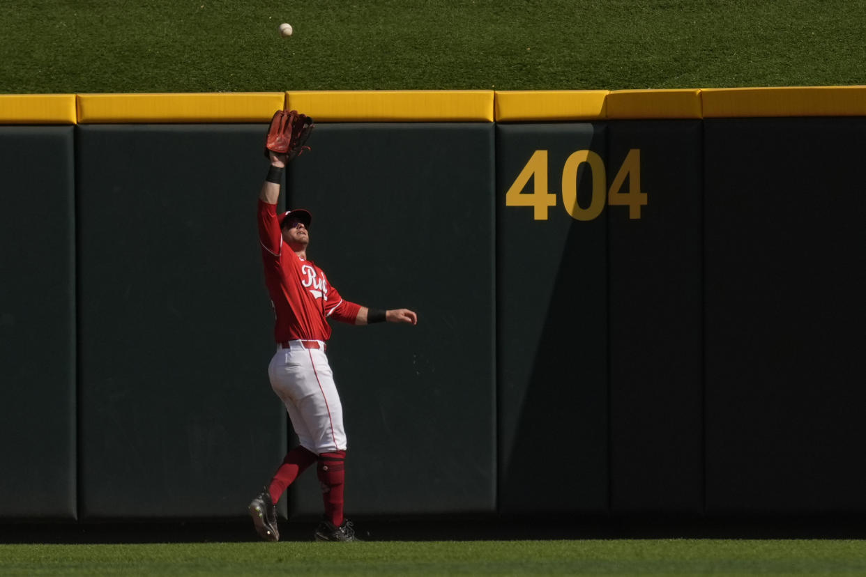 Cincinnati Reds center fielder TJ Friedl catches a fly ball hit by Pittsburgh Pirates' Oneil Cruz for the third out of the ninth inning of a baseball game, Saturday, Sept. 21, 2024, in Cincinnati. (AP Photo/Carolyn Kaster)