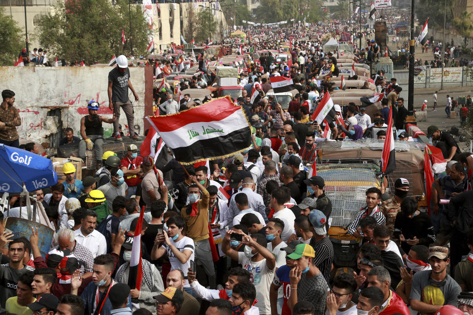 Anti-government protesters march close to the Joumhouriya Bridge that leads to the Green Zone government area, during ongoing protests in Baghdad, Iraq, Sunday, Nov. 3, 2019. (AP Photo/Hadi Mizban)