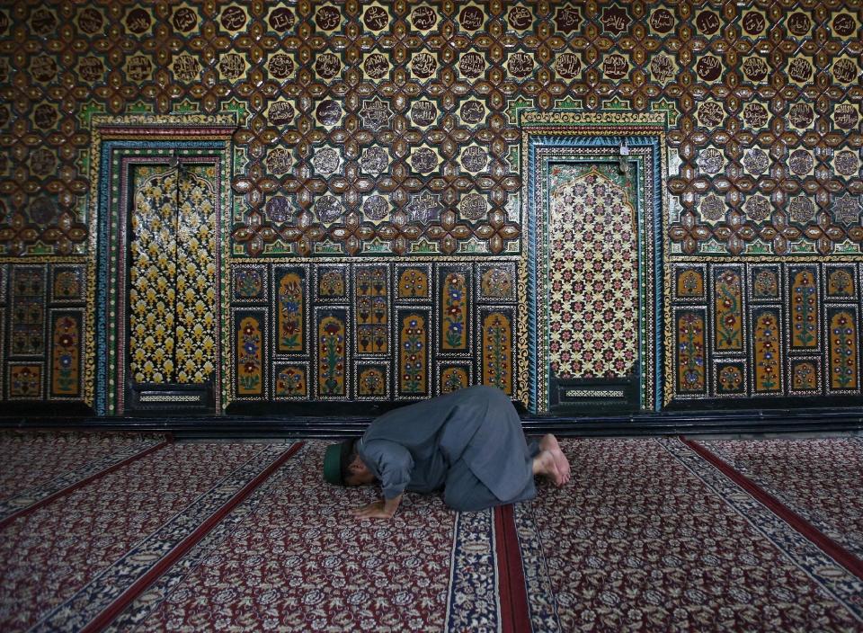 A Kashmiri Muslim man offers prayers at the shrine of Mir Syed Ali Hamdani, a Sufi saint, during the holy month of Ramadan in Srinagar July 7, 2015. (REUTERS/Danish Ismail)