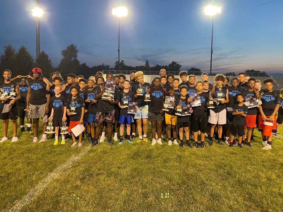 Brandon Hayes (middle), former NFL lineman, Muncie Southside High School graduate and founder of 3rd & 11 Inc., has organized four football combines for local youth that encourage exercise and sports participation.