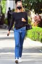<p>Karlie Kloss wears a black top with jeans and sneakers on her walk through N.Y.C. on Wednesday.</p>