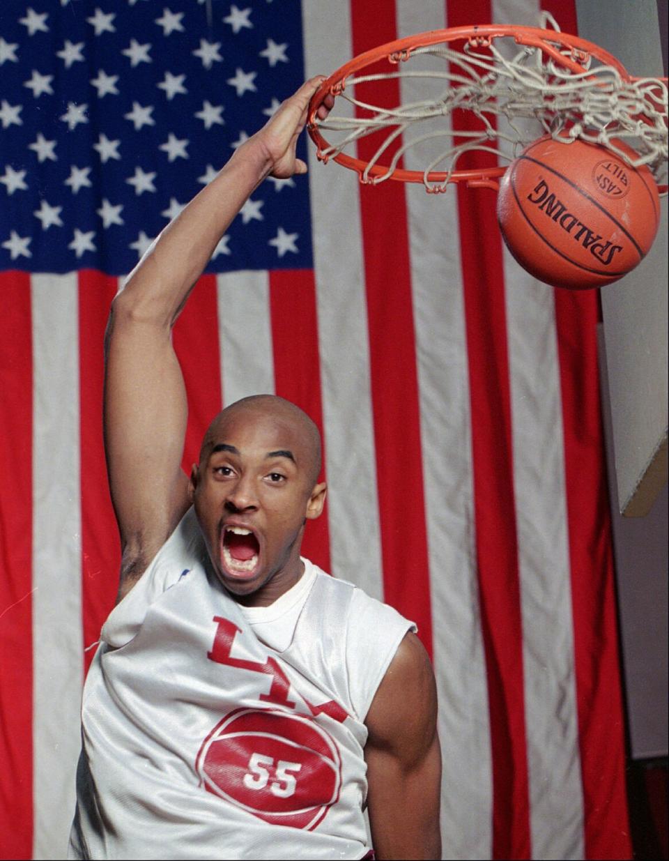 Kobe Bryant dunks the ball at the Lower Merion High gym.