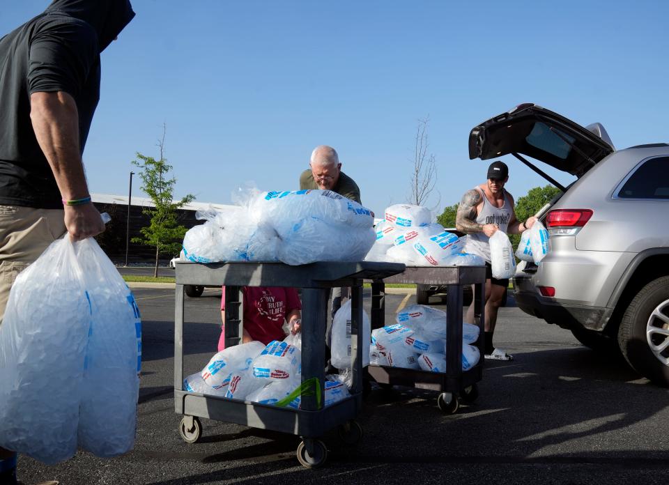 Columbus, Ohio, United States; Staff and volunteers unloaded hundreds of bags of donated ice and other supplies after the Franklin County Dog Shelter & Adoption Center lost power and had no air conditioning on Tuesday, June 14, 2022. Mandatory Credit: Barbara J. Perenic/Columbus Dispatch