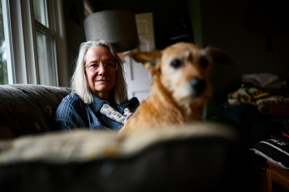 Mary Orem of Pendleton, South Carolina, poses for a portrait with her dog Dexter in her home Wednesday, Oct. 30, 2019. Orem, a former high school librarian, is one of 2,600 people who lost more than $451 million in a "scam" connected to Future Income Payments.