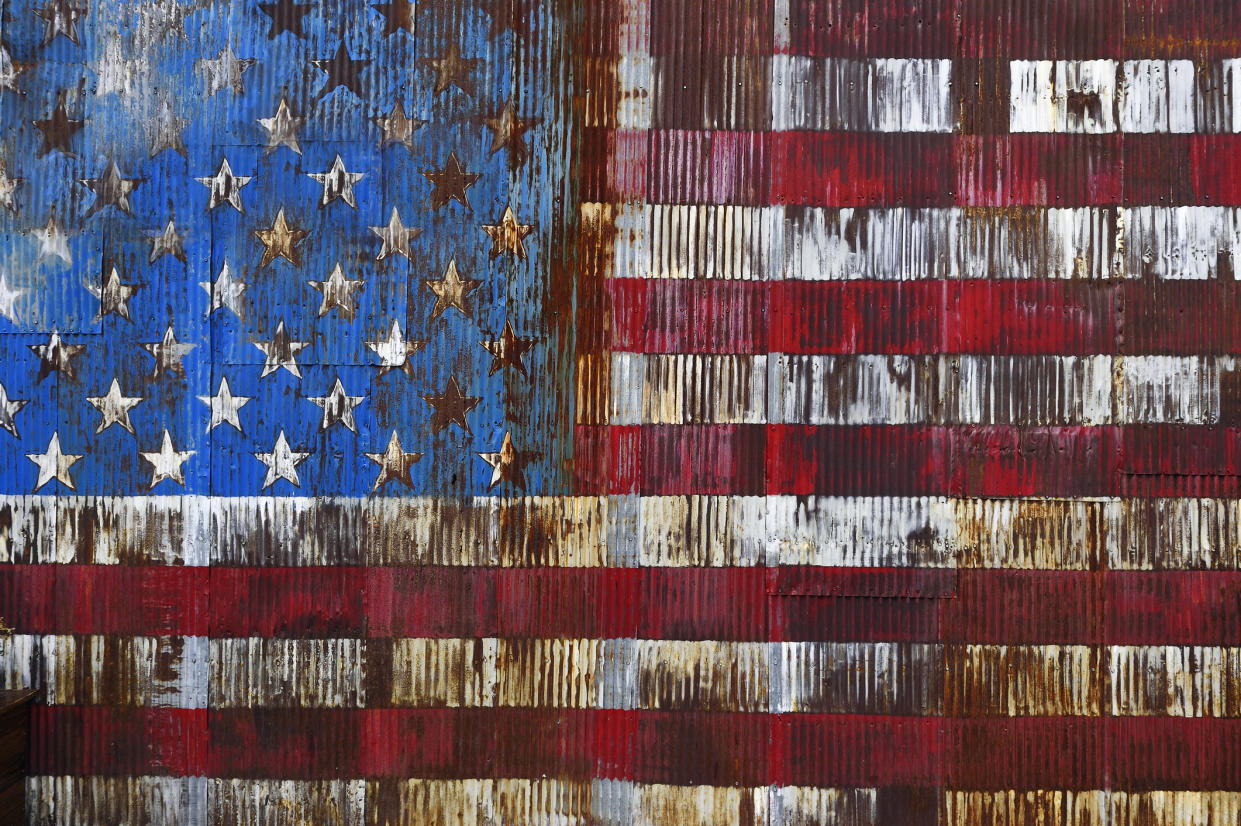 Decaying American Flag painted on a rusty door