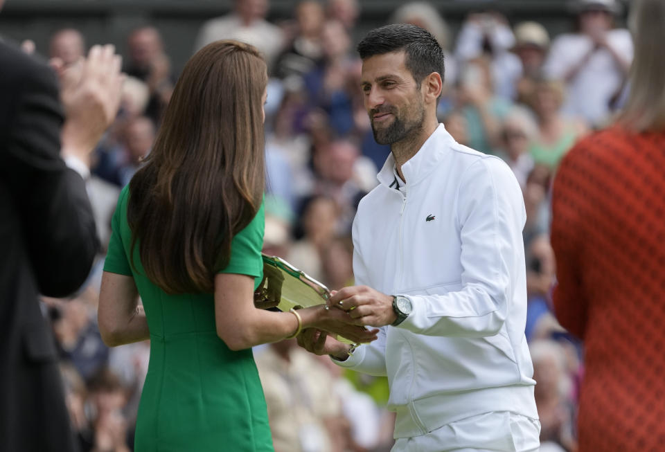 Serbia's Novak Djokovic receives the runners-up trophy from Kate, Princess of Wales after losing to Spain's Carlos Alcaraz in the final of the men's singles on day fourteen of the Wimbledon tennis championships in London, Sunday, July 16, 2023. (AP Photo/Kirsty Wigglesworth)