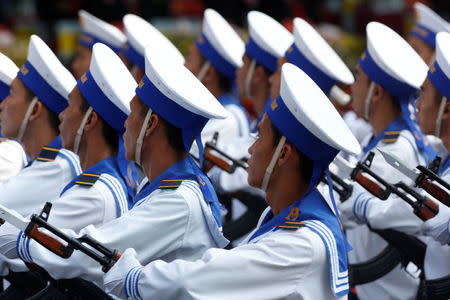 Sailors hold rifles while marching during a celebration to mark Reunification Day in Ho Chi Minh city, Vietnam April 30, 2015. REUTERS/Kham