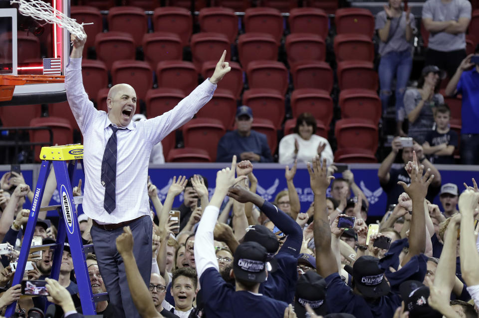 Utah State's head coach Craig Smith cuts off the net following an NCAA college basketball game against San Diego State for the Mountain West Conference men's tournament championship Saturday, March 7, 2020, in Las Vegas. (AP Photo/Isaac Brekken)