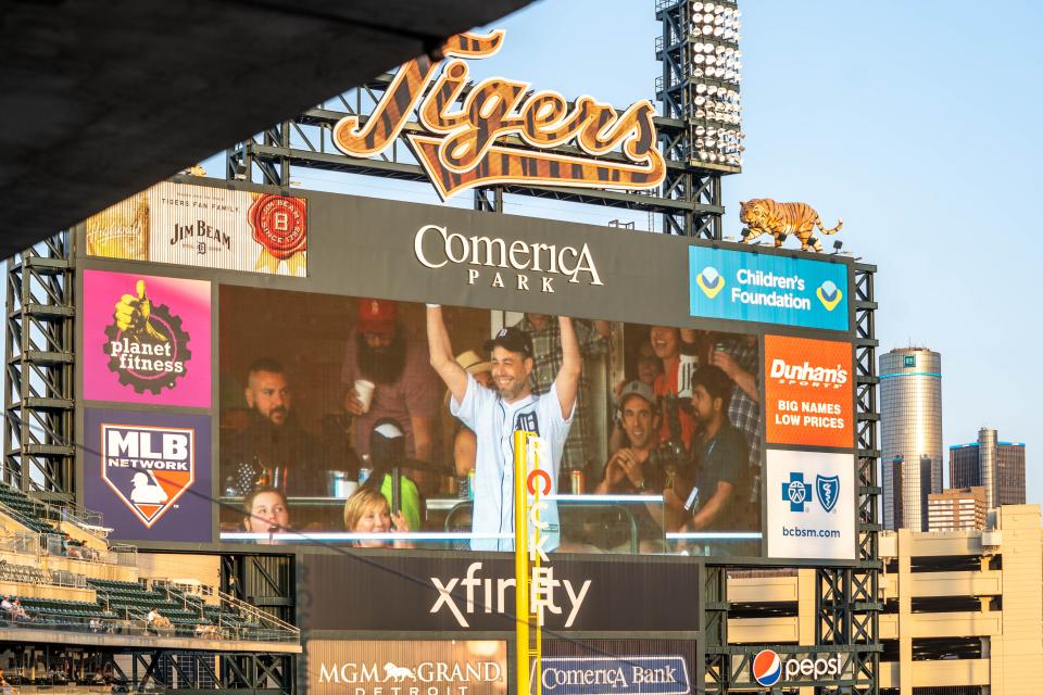 Jader Bignamini, music director of the Detroit Symphony Orchestra, appears on the outfield screen at Comerica Park in Detroit on June 14, 2022.