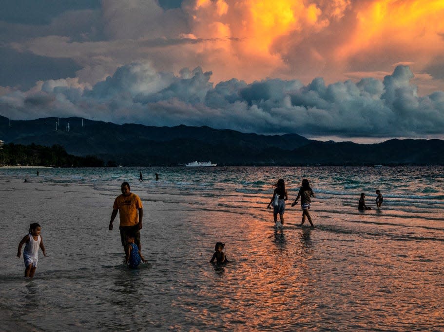 people by water in Boracay, Philippines