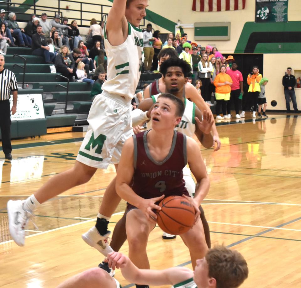 Union City's Aidan Decker (4) looks to go up strong in the paint versus Mendon Friday night