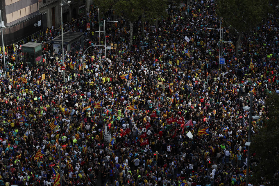 Protesters pack the street on the fifth day of protests over the conviction of a dozen Catalan independence leaders in Barcelona, Spain, Friday, Oct. 18, 2019. Tens of thousands of flag-waving demonstrators demanding Catalonia's independence and the release from prison of their separatist leaders have flooded downtown Barcelona. The protesters have poured into the city after some of them walked for three days in "Freedom marches" from towns across the northeastern Spanish region, joining students and workers who have also taken to the streets on a general strike day. (AP Photo/Manu Fernandez)