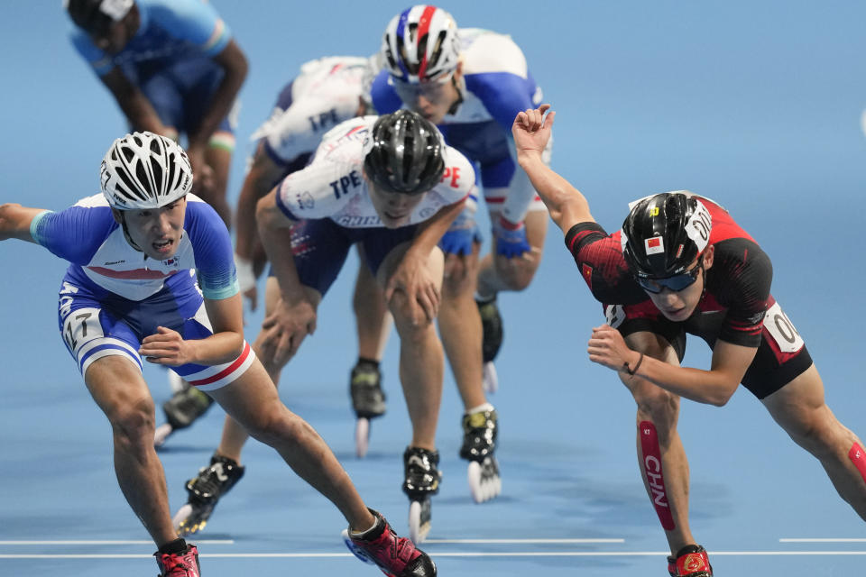 Zhenhai Zhang, right. of China, leads the pack at the men's Speed Skating 10000m Point-Elimination Race event of the 19th Asian Games in Hangzhou, China, Saturday, Sept. 30, 2023. Byeongchee won the gold. (AP Photo/Aaron Favila)