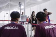 Visitors pass through a thermal scanner as they arrive the Singapore Air Show on Tuesday, Feb. 11, 2020, in Singapore. (AP Photo/Danial Hakim)