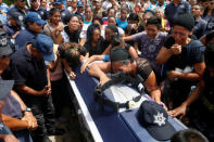 Relatives mourn on top of the coffin of police officer Juan Jimenez, who was a victim of the earthquake that struck the southern coast of Mexico late on Thursday, during his burial in Juchitan, Mexico, September 10, 2017. REUTERS/Carlos Jasso