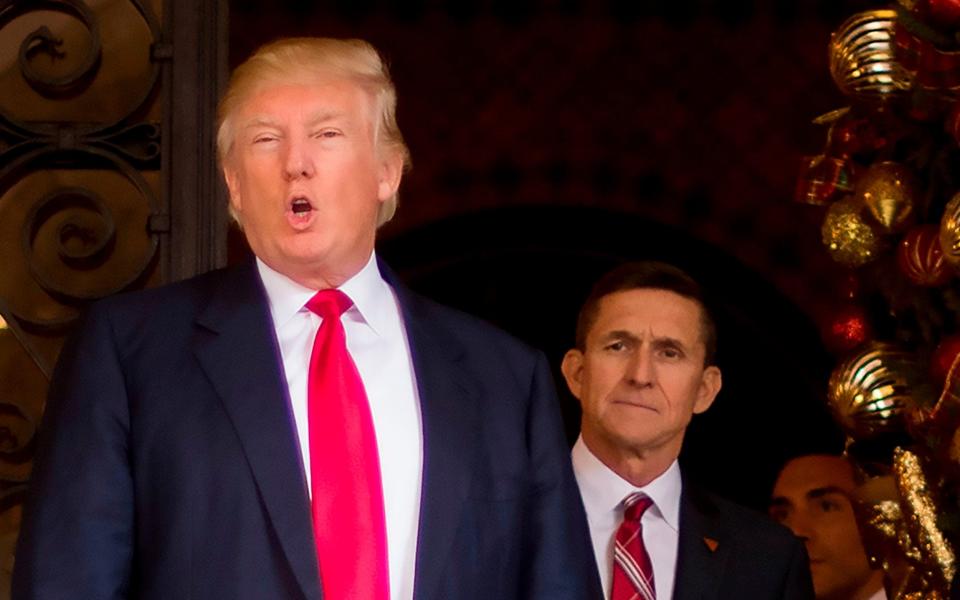 Donald Trump stands with Trump National Security Adviser designate Lt. General Michael Flynn  - AFP
