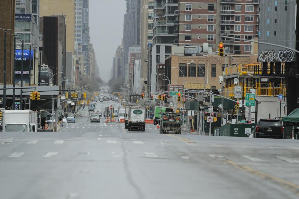 Cars navigate a mostly empty 11th avenue Friday, April 3, 2020, in New York. The new coronavirus causes mild or moderate symptoms for most people, but for some, especially older adults and people with existing health problems, it can cause more severe illness or death. (AP Photo/Frank Franklin II)