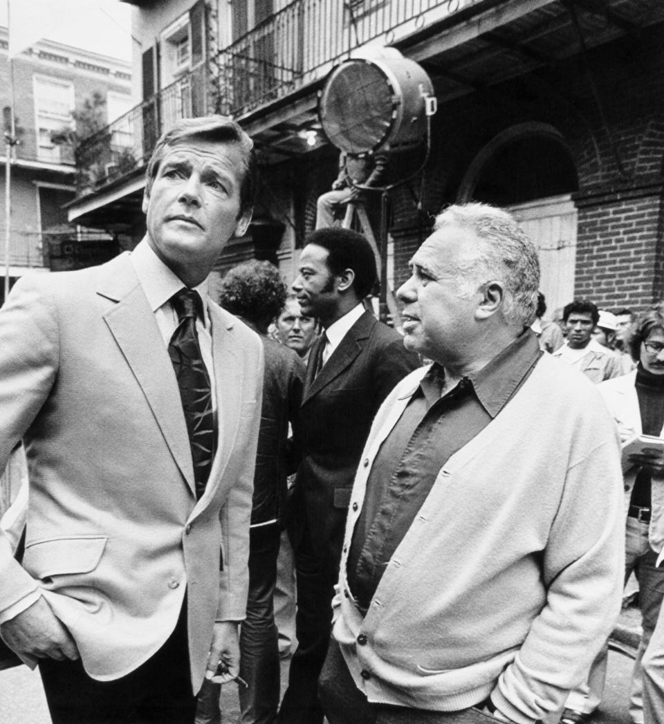 Producer Harry Saltzman (R), on location in the historic french Quarter filming his eighth 007 spy thriller, talking with the newest James Bond, British actor Roger Moore. 
 Moore, the 3rd actor to play 007 for Saltzman has long been identified with the TV role of Simon Templar, 