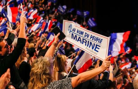People cheer as Marine Le Pen, French National Front (FN) political party leader and candidate for the French 2017 presidential election, attends the 2-day FN political rally to launch the presidential campaign in Lyon, France February 5, 2017. REUTERS//Robert Pratta