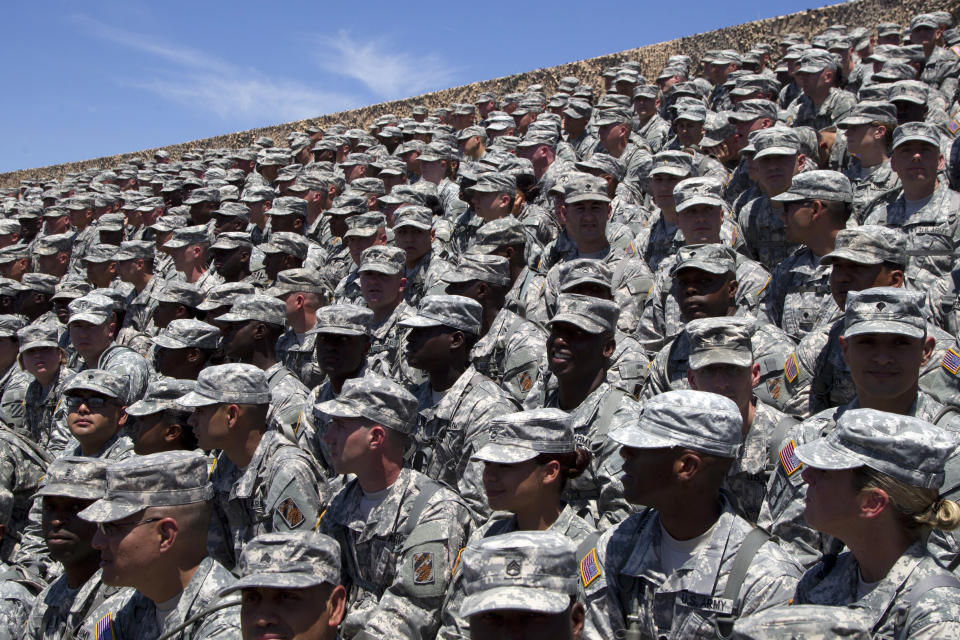 File - Troops wait for President Barack Obama to arrive at the Third Infantry Division Headquarters, on April 27, 2012, at Fort Stewart, Ga. Among health-related efforts is a pilot project involving the entire Third Infantry Division — more than 13,000 soldiers. Tracking soldiers' physical fitness, predictive modeling and AI are used to reduce injuries and increase performance (AP Photo/Carolyn Kaster, File)