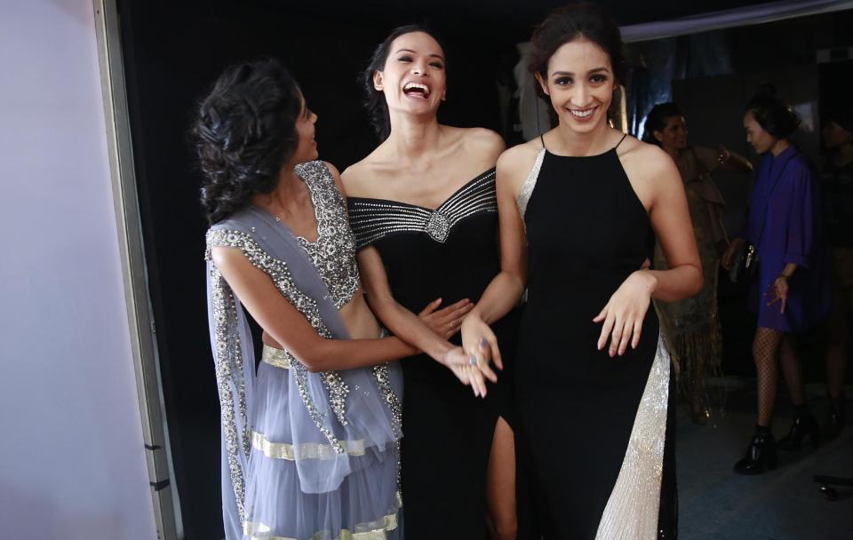 In this Feb. 1, 2017 photo, Anjali Lama, center, a transgender model from Nepal, interacts with other models after walking the ramp during Lakme Fashion week in Mumbai, India. To model for Lakme Fashion Week, one of the highlights of India's fashion calendar, is Lama's big moment. It's a dream that was years in the making and often seemed far beyond the reach of Lama now being touted as the first transgender woman to model for the high fashion event sponsored by a top Indian cosmetics brand. (AP Photo/Rafiq Maqbool)