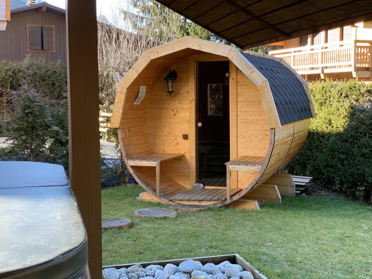 The exterior of a ski sauna in the back yard of a ski chalet rental in Sameon, France.