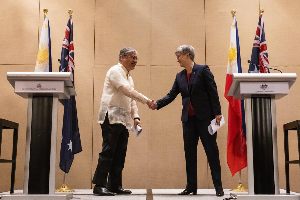 Australian Foreign Minister Penny Wong, right, and Philippine Foreign Affairs Secretary Enrique Manalo shake hands during a joint press conference at a hotel in Makati City, Philippines on Thursday May 18, 2023. (Lisa Marie David/Pool Photo via AP)