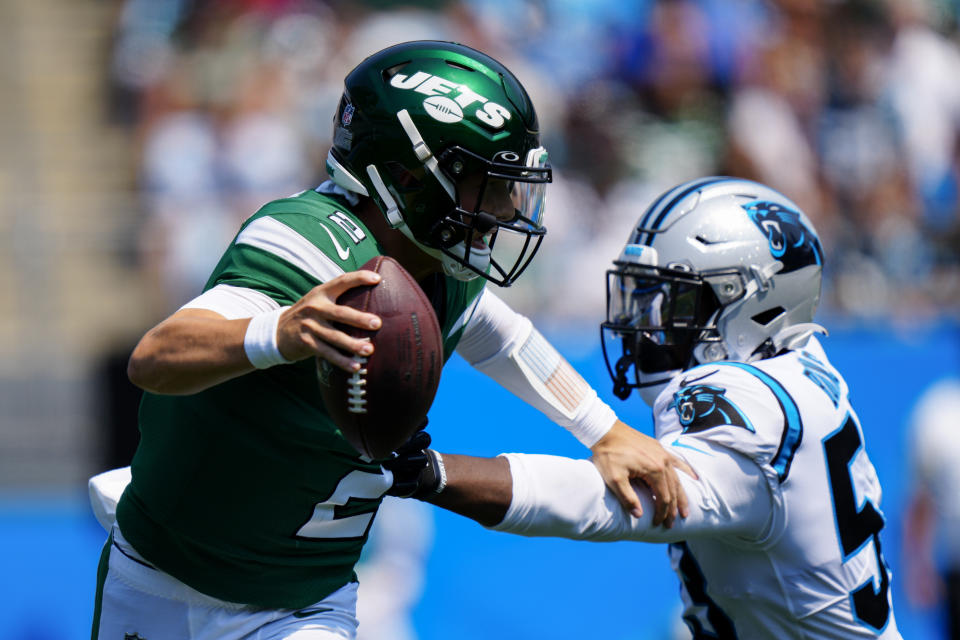 New York Jets quarterback Zach Wilson pushes away Carolina Panthers defensive end Brian Burns during the first half of an NFL football game Sunday, Sept. 12, 2021, in Charlotte, N.C. (AP Photo/Jacob Kupferman)