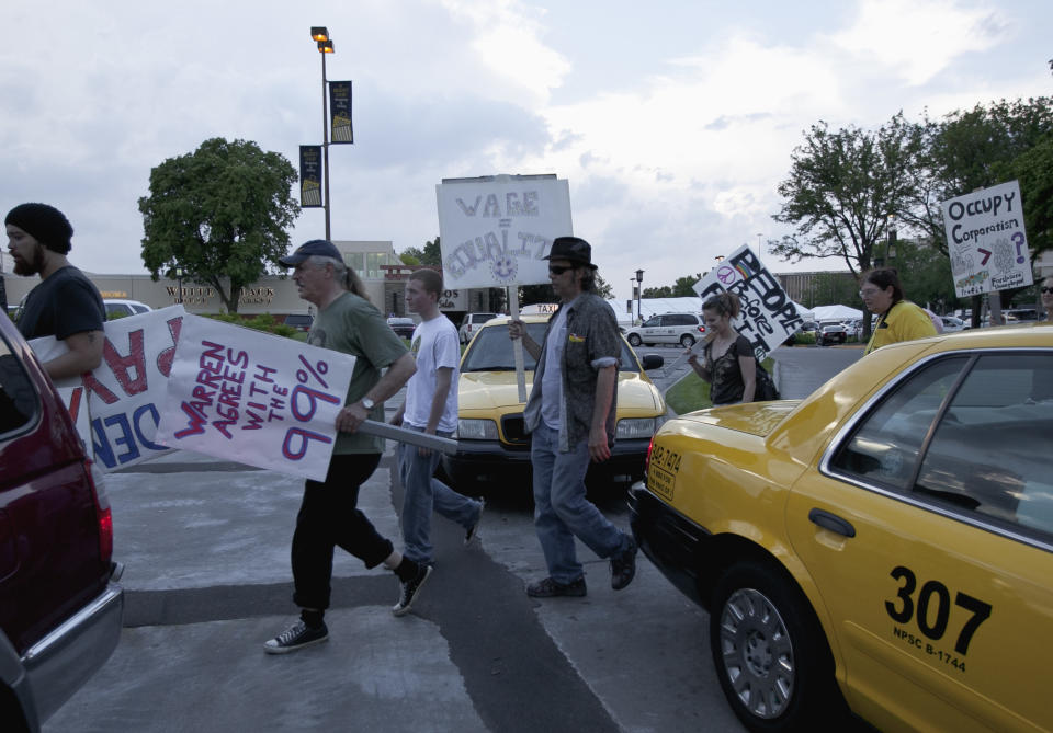 Members of Occupy Omaha picket outside the Berkshire-owned Borsheims jewelry store in Omaha, Neb., Friday, May 4, 2012, as a cocktail party for shareholders takes place. Berkshire Hathaway is expected to have 30,000 shareholders come to Omaha for it's annual shareholders meeting this weekend. (AP Photo/Nati Harnik)