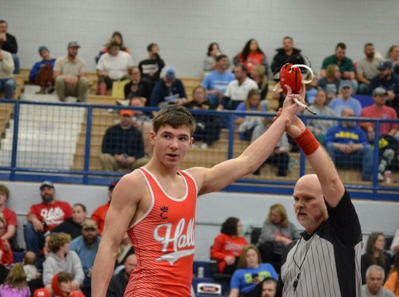 Barrett Whaley has his hand raised in victory.