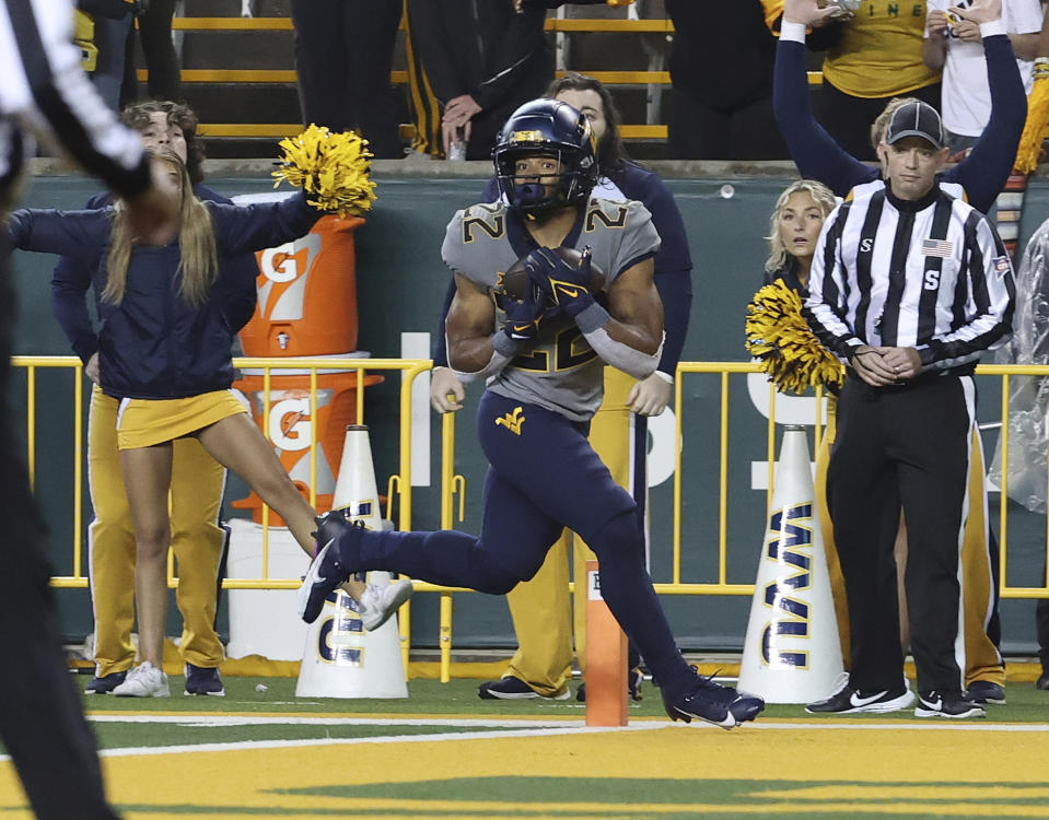 West Virginia running back Jahiem White (22) catches a pass for the winning touchdown in the fourth quarter of an NCAA college football game, Saturday, Nov. 25, 2023, in Waco, Texas. (Jerry Larson/Waco Tribune-Herald, via AP)