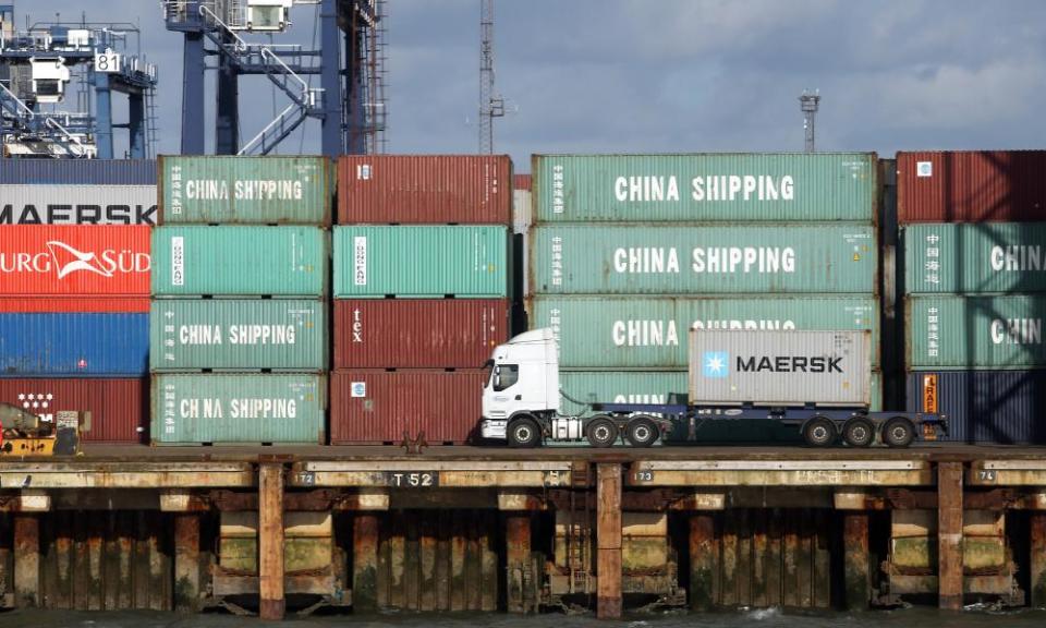 A freight lorry delivers a container to port