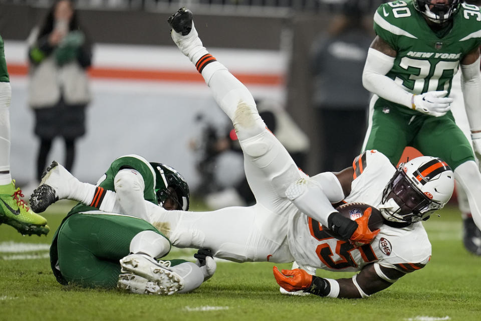 Cleveland Browns tight end David Njoku is tackled by New York Jets safety Tony Adams during the first half of an NFL football game Thursday, Dec. 28, 2023, in Cleveland. (AP Photo/Sue Ogrocki)