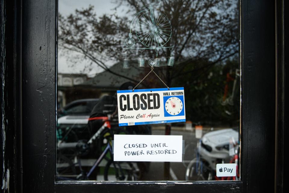 A closed sign hangs from Rainbow Cycles Inc. in Southern Pines telling customers they will reopen when the power is restored on Tuesday, Dec. 6, 2022. Power is out in Southern Pines due to an attack on power substations on Saturday night.
