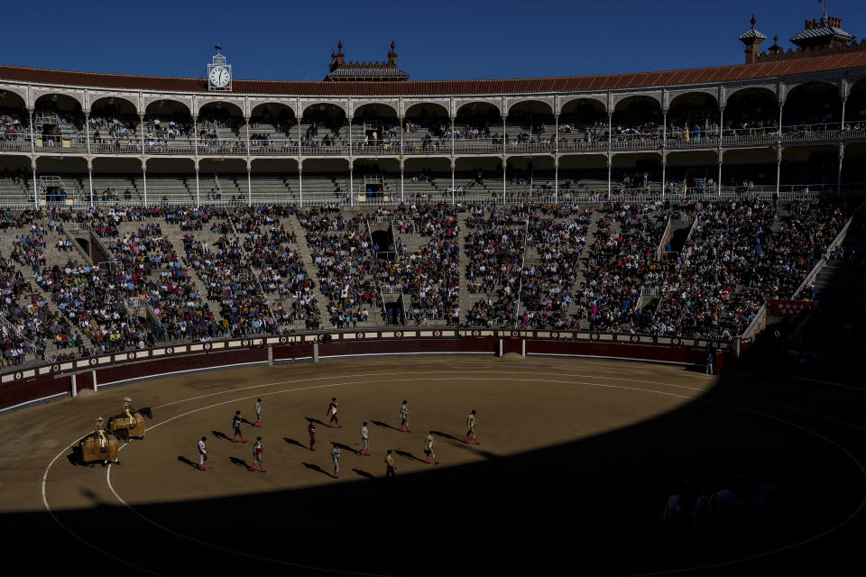 Bullfighters followed by their assistants walk during the 'paseillo' or ritual entrance to the arena, before a bullfight with young bulls, at Las Ventas bullring in Madrid, Spain, Sunday, March 26, 2023. The death of Spanish bullfighting has been declared many times, but the number of bullfights in the country is at its highest level in seven years, and the young are the most consistent presence as older groups of spectators drop away. (AP Photo/Manu Fernandez)
