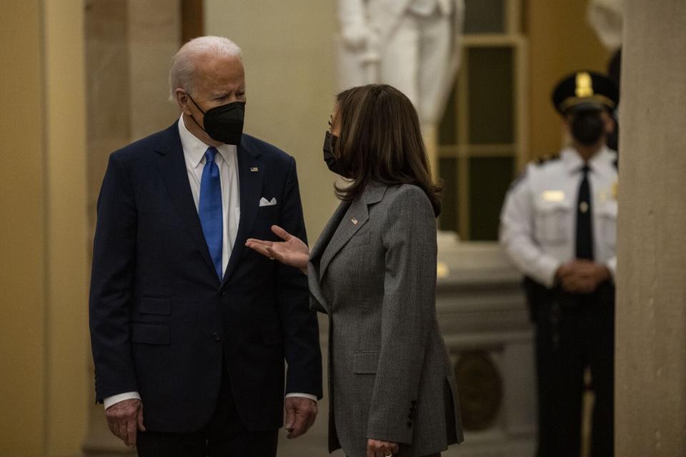 President Biden and Vice President Kamala Harris talk in the Capitol