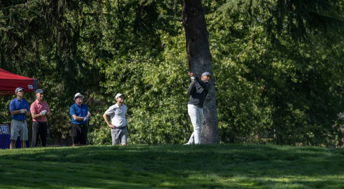 Former NBA player Derek Fisher follows through on his drive during the Phil Oates Celebrity Golf Classic at North Ridge Country Club in Fair Oaks on Monday.